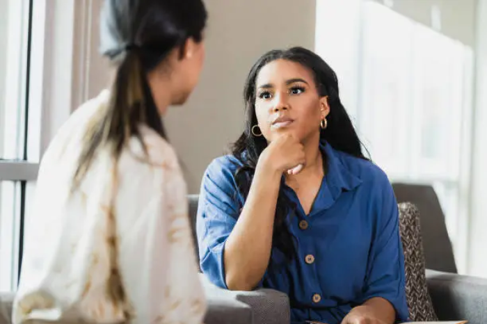 Two people discussing businesses